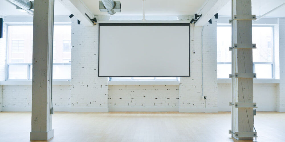 projector-screen-pulled-down-covers-a-window